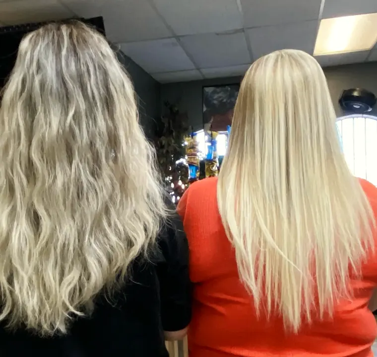 Two clients side by side: soft beachy blonde waves and sleek, straight bright blonde.